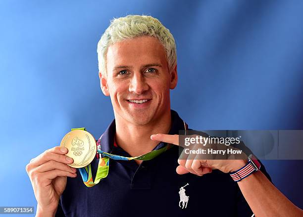 Swimmer, Ryan Lochte of the United States poses for a photo with his gold medal on the Today show set on Copacabana Beach on August 12, 2016 in Rio...