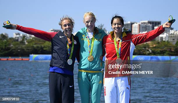 Gold medallist Australia's Kimberley Brennan is flanked by silver medallist US' Genevra Stone and bronze medallist China's Duan Jingli as they...
