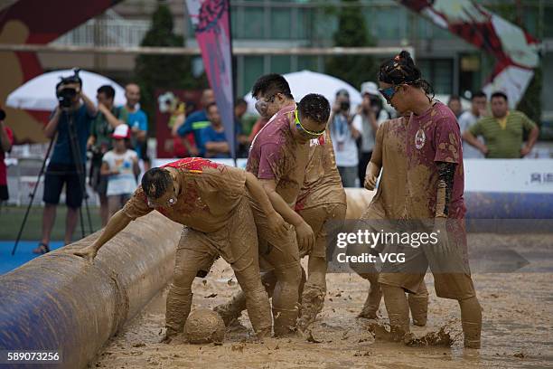 Players battle for the ball during the first station match of 2016 Swamp Soccer China tournament at Yuetan Park on August 13, 2016 in Beijing, China....