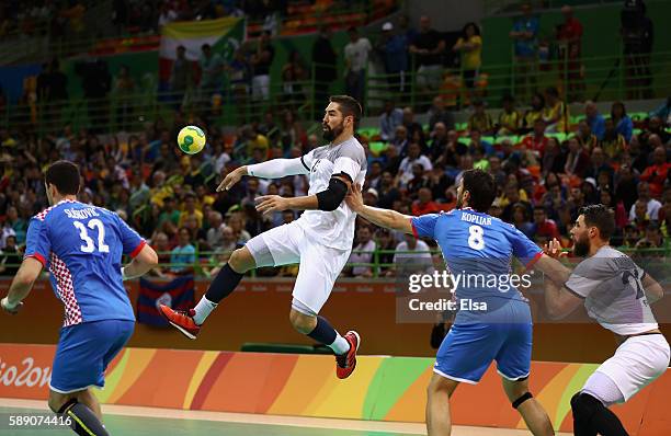 Nikola Karabatic of France is challenged by Ivan Sliskovic and Marko Kopljar of Croatia during the Men's Handball preliminary Group A match between...