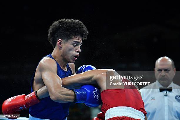 S Antonio Vargas blocks a punch from Brazil's Juliao Neto during the Men's Fly at the Rio 2016 Olympic Games at the Riocentro - Pavilion 6 in Rio de...