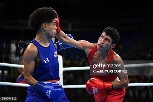 Brazil's Juliao Neto throws a punch towards USA's Antonio Vargas during the Men's Fly at the Rio 2016 Olympic Games at the Riocentro - Pavilion 6 in...