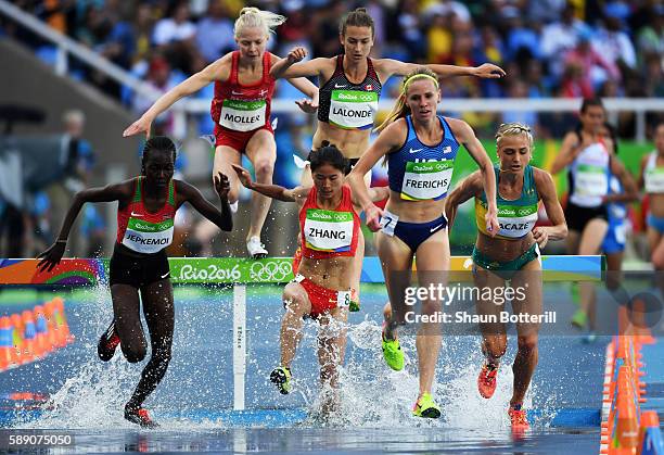 Xinyan Zhang of China, Courtney Frerichs of the United States and Hyvin Kiyeng Jepkemoi of Kenya compete in the Women's 3000m Steeplechase Round 1 on...