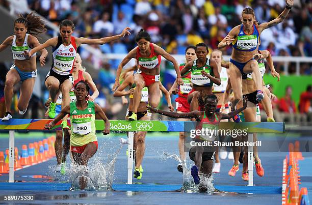 Xinyan Zhang of China, Etenesh Diro of Ethiopia and Hyvin Kiyeng Jepkemoi of Kenya compete in the Women's 3000m Steeplechase Round 1 on Day 8 of the...