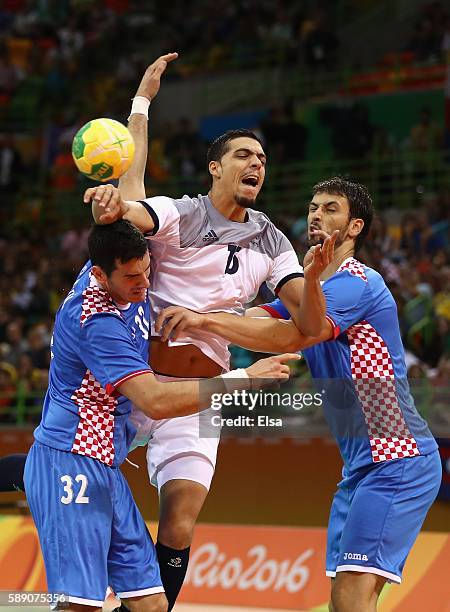 Mathieu Grebille of France in action against Ivan Sliskovic and Marko Kopljar of Croatia during the Men's Handball preliminary Group A match between...