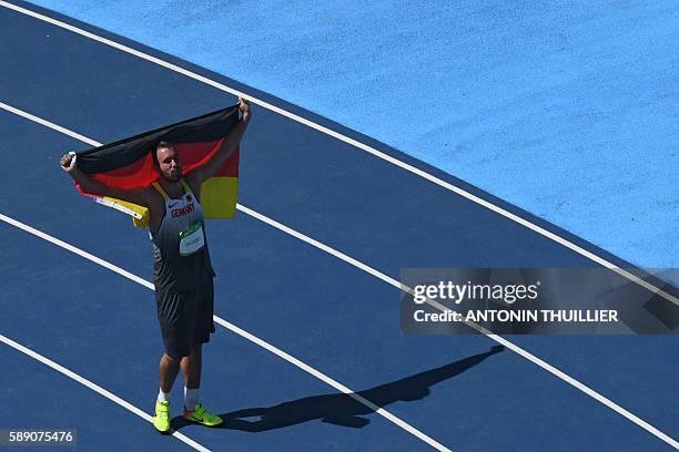 Gold medallist Germany's Christoph Harting celebrates winning the Men's Discus Throw Final during the athletics event at the Rio 2016 Olympic Games...