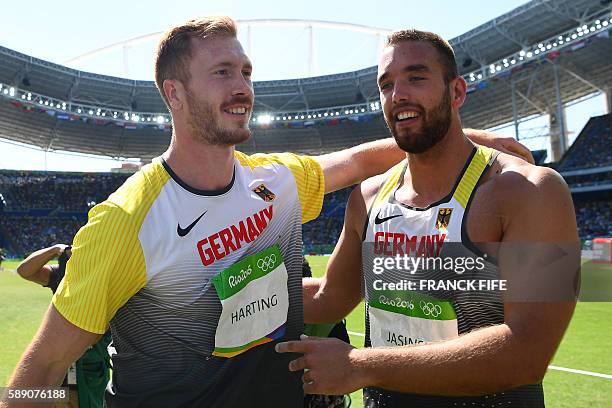 Gold medallist Germany's Christoph Harting celebrates with bronze medallist Germany's Daniel Jasinski after the Men's Discus Throw Final during the...