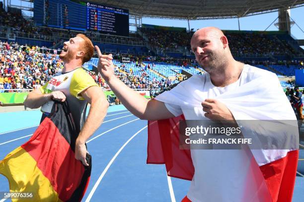 Gold medallist Germany's Christoph Harting celebrates with silver medallist Poland's Piotr Malachowski after the Men's Discus Throw Final during the...