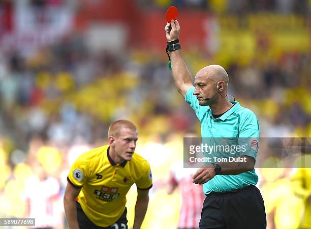 Referee Roger East sends off Ben Watson of Watford during the Premier League match between Southampton and Watford at St Mary's Stadium on August 13,...