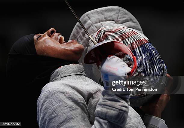 Ibtihaj Muhammad of the United States reacts against Sofya Velikaya of Russia during the Women's Sabre Team Semifinal 1 Russia vs United States at...