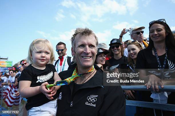 Gold medalist Mahe Drysdale of New Zealand celebrates with his daughter Bronte after the medal ceremony for the Men's Single Sculls on Day 8 of the...