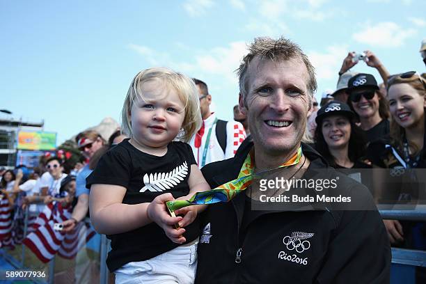 Gold medalist Mahe Drysdale of New Zealand celebrates with his daughter Bronte after the medal ceremony for the Men's Single Sculls on Day 8 of the...