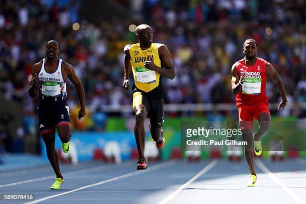 Usain Bolt of Jamaica, Richard Thompson of Trinidad and Tobago and James Dasaolu of Great Britain compete in the Men's 100m Round 1 on Day 8 of the...