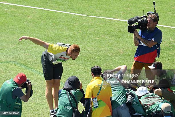 Germany's Christoph Harting celebrates winning the Men's Discus Throw Final during the athletics event at the Rio 2016 Olympic Games at the Olympic...