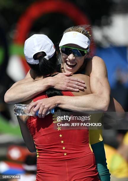 Australia's Kimberley Brennan and China's Duan Jingli hug each other after the Women's Single Sculls final rowing competition at the Lagoa stadium...