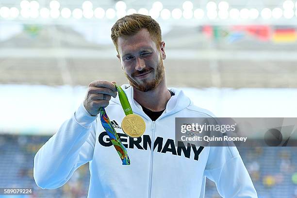 Gold medalist Christoph Harting of Germany poses on the podium during the medal ceremony for the Men's Discus Throw Final on Day 8 of the Rio 2016...