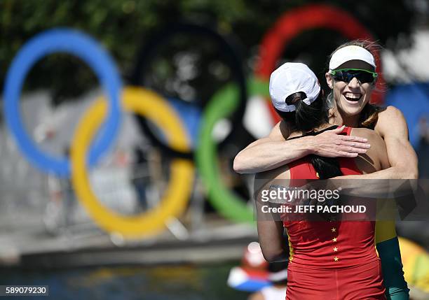 Australia's Kimberley Brennan and China's Duan Jingli hug each other after the Women's Single Sculls final rowing competition at the Lagoa stadium...