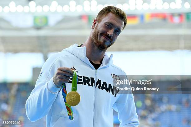 Gold medalist Christoph Harting of Germany poses on the podium during the medal ceremony for the Men's Discus Throw Final on Day 8 of the Rio 2016...
