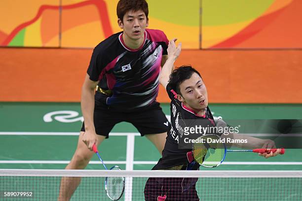 Yong Dae Lee and Yeon Seong Yoo of Republic of Korea compete against Vladimir Ivanov and Ivan Sozonov of Russia the Men's Doubless Play Stage Group A...
