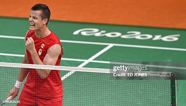 Canada's Martin Giuffre reacts after beating Portugal's Pedro Martins during their men's singles qualifying badminton match at the Riocentro stadium...