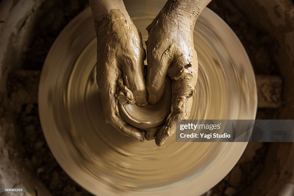 The woman using the potter's wheel in pottery