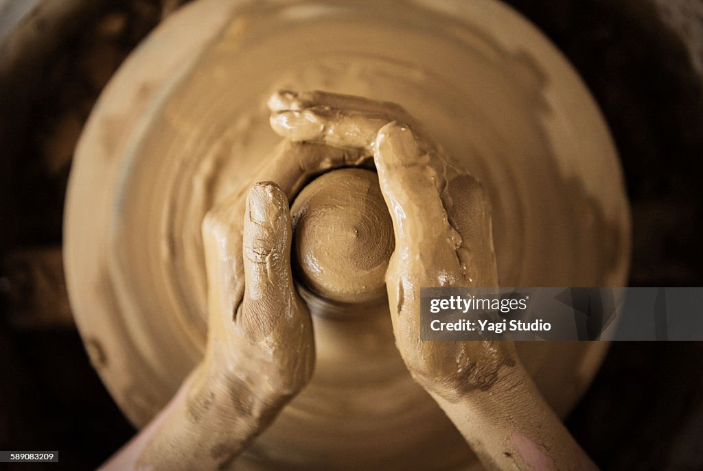 The woman using the potter's wheel in pottery