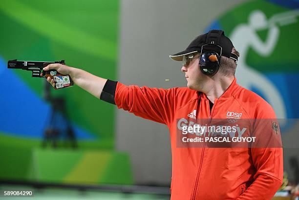 Gold medal winner Germany's Christian Reitz competes during the 25m Rapid Fire Pistol men's final at the Olympic Shooting Centre in Rio de Janeiro on...