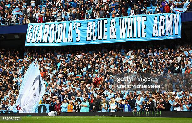 Manchester City fans display banners in surport of Josep Guardiola, Manager of Manchester City during the Premier League match between Manchester...