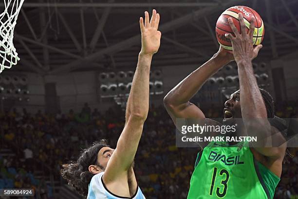 Argentina's power forward Luis Scola defends against Brazil's centre Nene Hilario during a Men's round Group B basketball match between Argentina and...