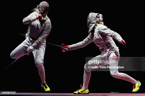 Dagmara Wozniak of the United States competes against Aleksandra Socha of Poland in the Women's Sabre Team Quarterfinal United States vs Poland at...