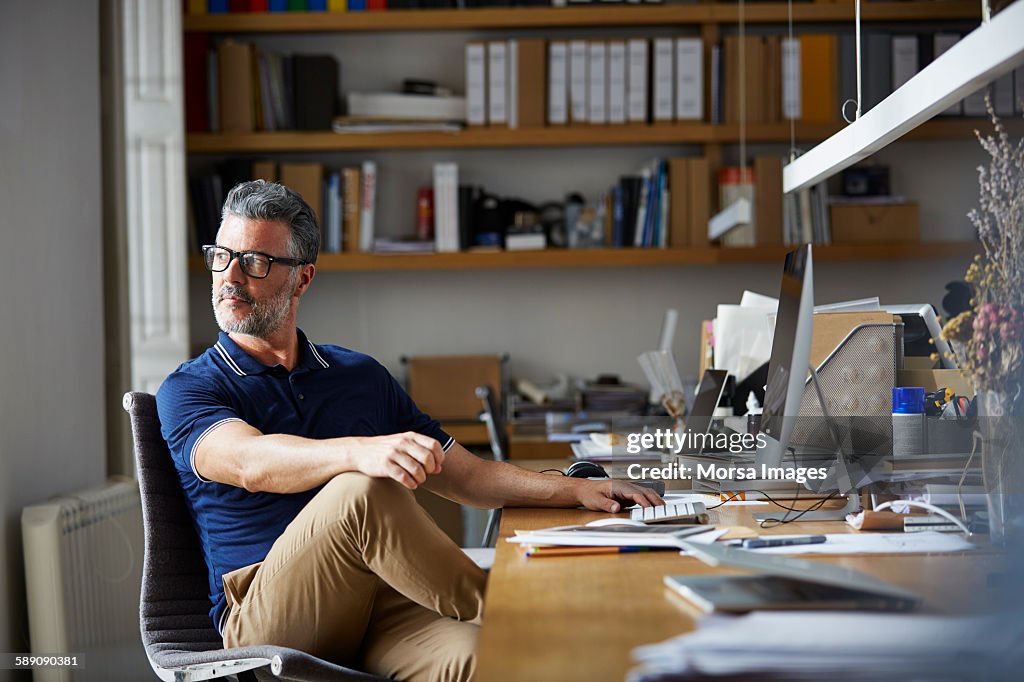 Thoughtful businessman sitting at desk