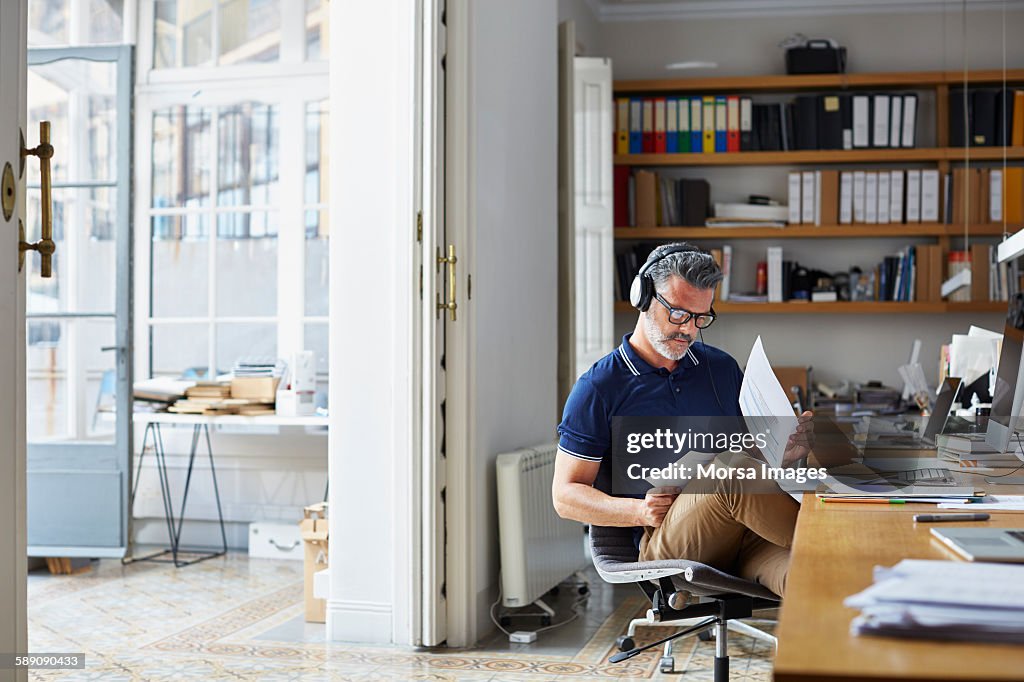 Businessman examining documents at desk