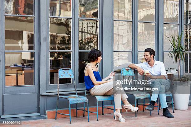 business colleagues having a coffee break outside - legs crossed at knee stock pictures, royalty-free photos & images