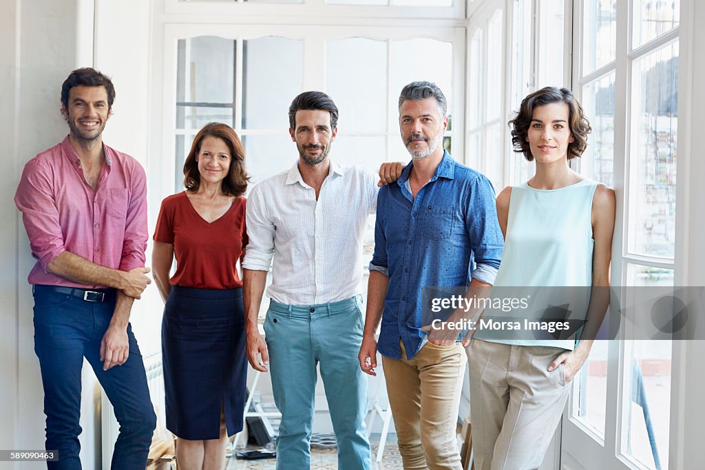 Confident business people standing in office