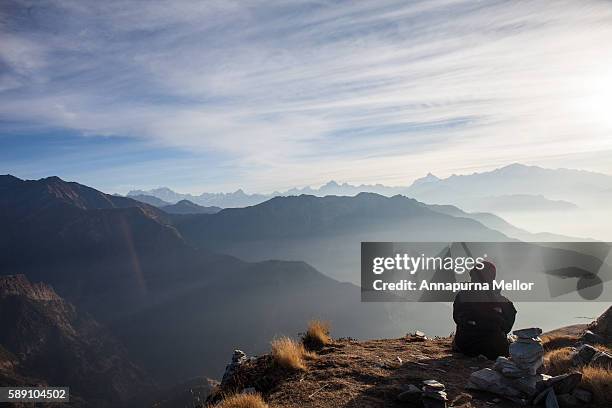 a tourist admires the himalayan sunrise in chopta, uttarakhand, india - uttarakhand stock pictures, royalty-free photos & images