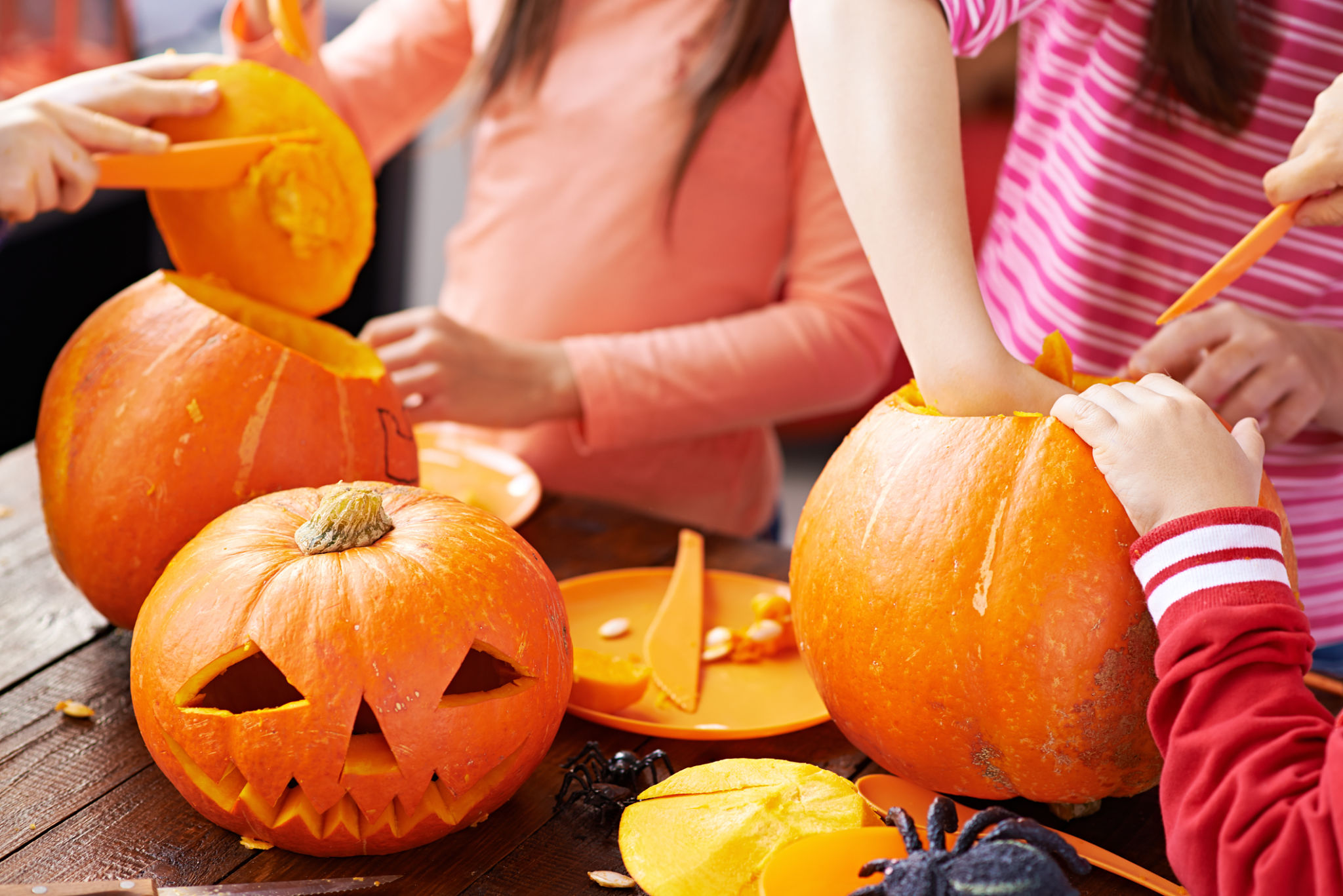family carving pumpkins