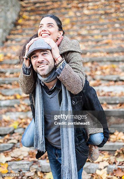 young people in piggyback ride outdoors - man fallen up the stairs stock pictures, royalty-free photos & images