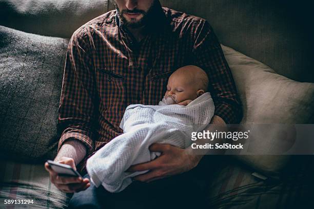 finally, i have a break! - father holding sleeping baby imagens e fotografias de stock