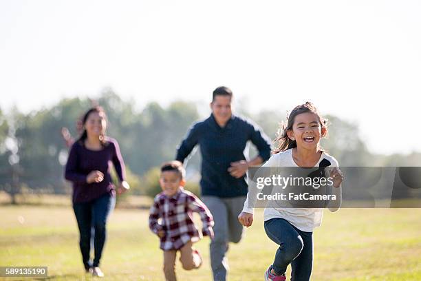 chasing each other outside - canadian culture stock pictures, royalty-free photos & images