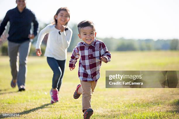 playing outside on father's day - boy running back stock pictures, royalty-free photos & images