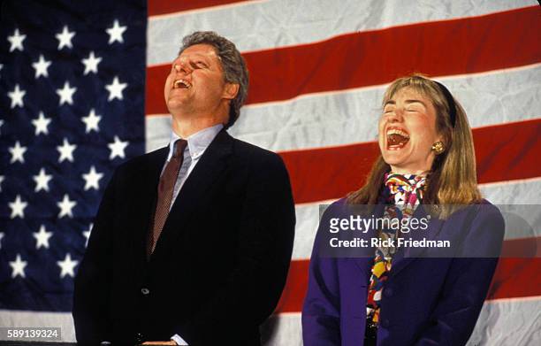 Bill Clinton and Hillary Rodham Clinton laugh as they are about to be introduced at a rally in prior to the New Hampshire primary election.
