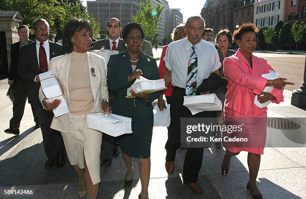 Member of Congress, front from left to right, Rep. Maxine Waters, D-Calif., Rep. Shelia Jackson Lee, D-Texas, Rep. John Conyers, D-Mich., ranking...