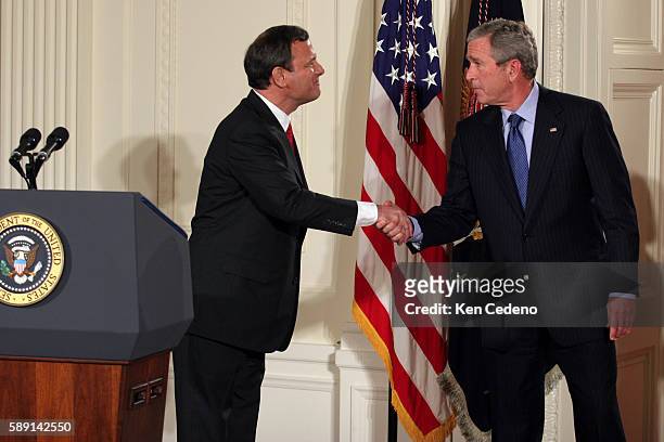 Chief Justice of the United States John Roberts shakes the hand of President George W. Bush after Roberts was sworn in by Supreme Court Justice John...