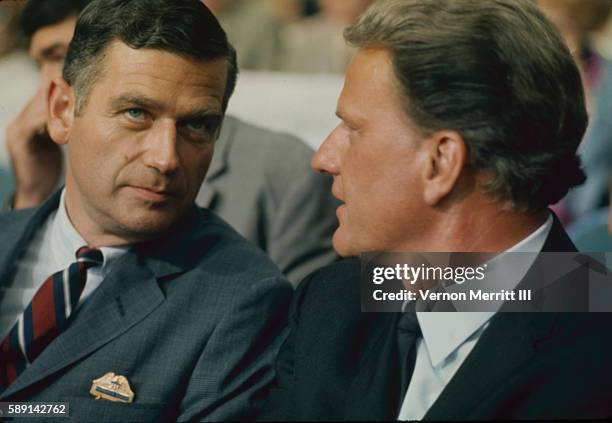 American politician Sentaor Mark Hatfield talks with evanelist Billy Graham as they sit together on the floor of the Republican National Convention...