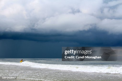 Surfer and storm Surfer and storm