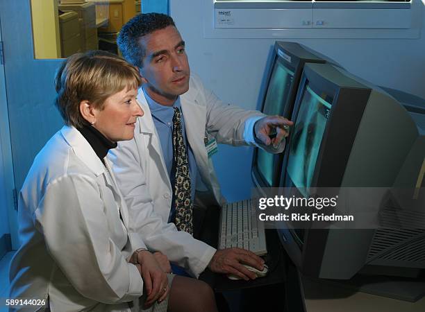 Dr. Glenn Hebel and Dr. Lynn Francis use a state-of-the-art computerized X-ray system at Newport Hospital.