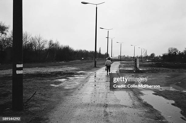 Man walking along a pedestrianised section of the course of the former Berlin Wall, south-west Berlin. The Berlin Wall was a barrier constructed by...