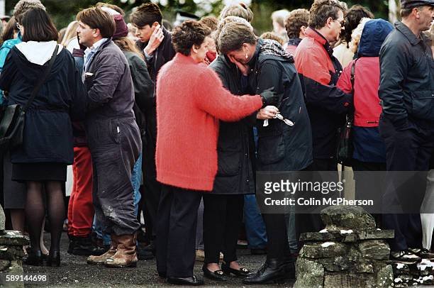 Crying won is comforted outside Dunblane primary school, Scotland, shortly after hearing the shooting incident on the premises. The Dunblane school...