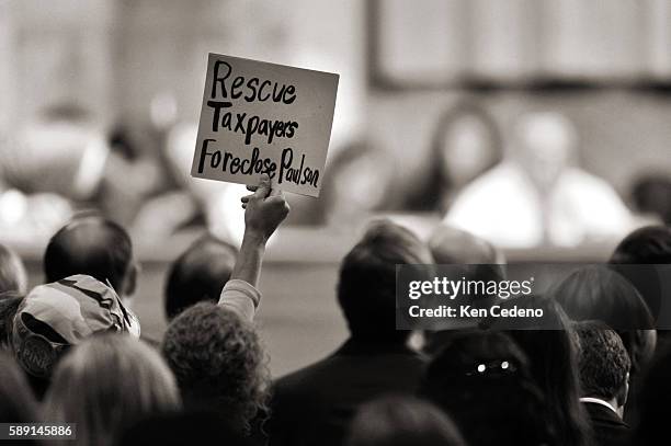 Code Pink protestors express their views with signs at the Senate Banking, Housing and Urban Affairs Committee on Capitol Hill in Washington, DC.