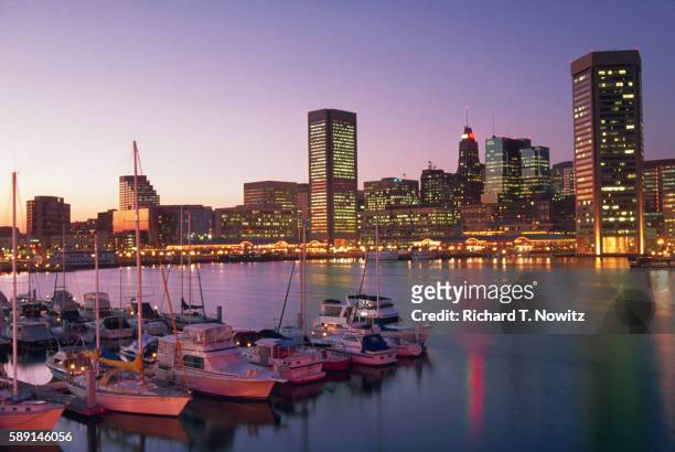 baltimore's inner harbor in the evening - baltimore maryland stock pictures, royalty-free photos & images